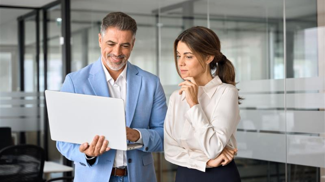 Colleagues looking at their computers