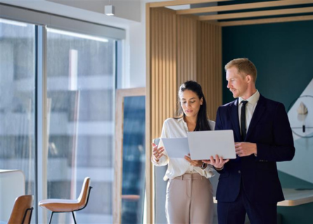 Due professionisti si confrontano davanti al pc, collaborando insieme