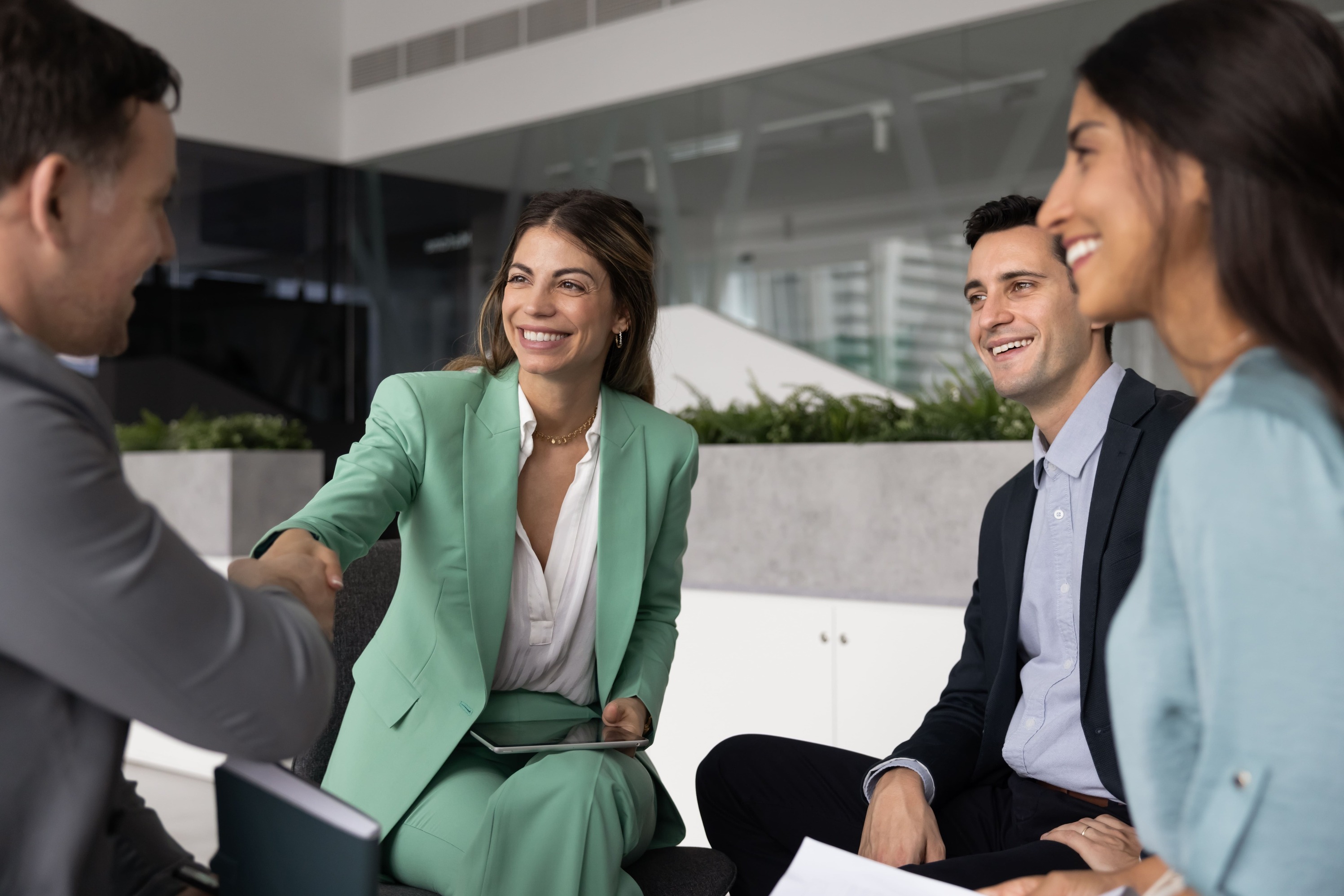 Smiling colleagues shaking hands